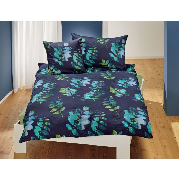 Linge de lit avec motif de feuilles sur fond bleu foncé